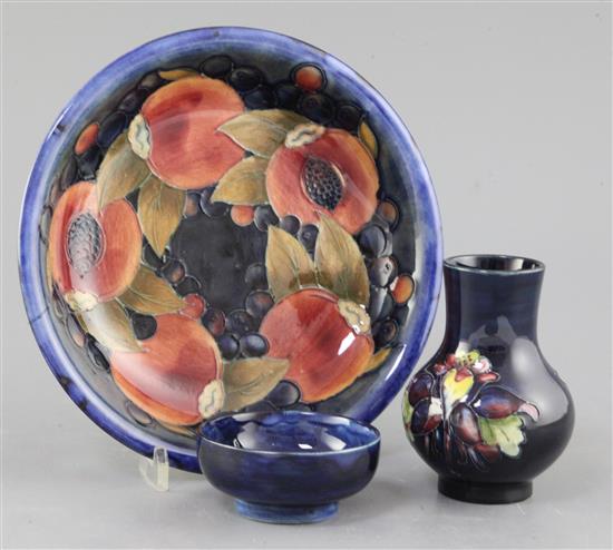 A Moorcroft pomegranate pattern dish, a tiger lily pattern small vase and a hibiscus pattern dish, 8cm - 20.5cm